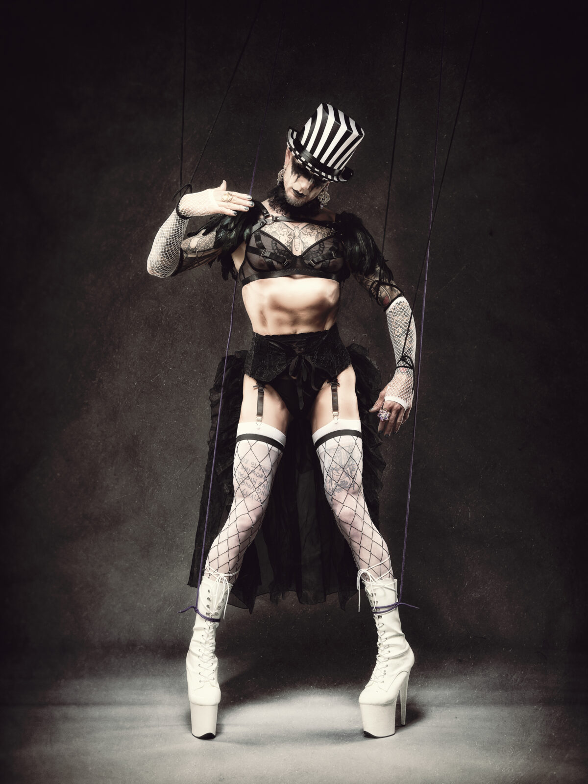 Fetischporträt mit Netzoptik, Korsage, Strapsen und Puppenschnüren – kreative Studiofotografie Düsseldorf